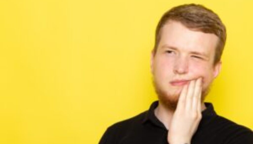 front-view-young-male-black-shirt-posing-having-toothache-min