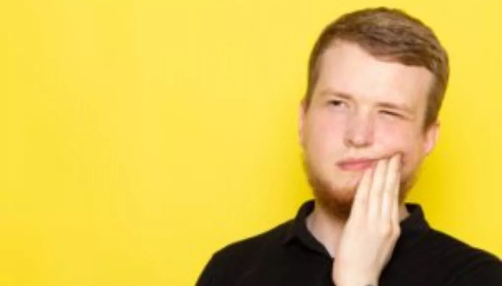 front-view-young-male-black-shirt-posing-having-toothache-min