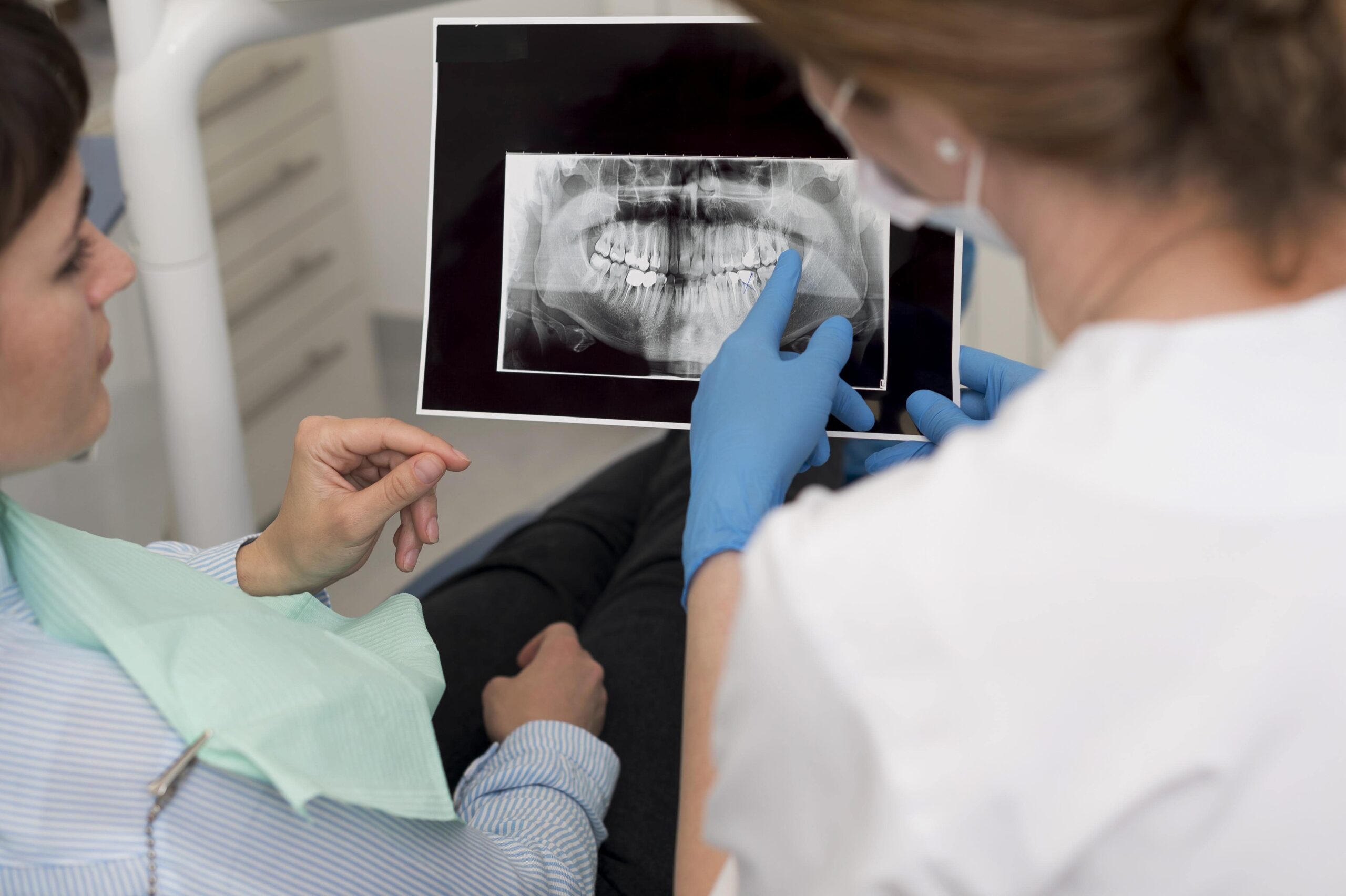 female-patient-looking-radiography-her-teeth-with-dentist (1)-min