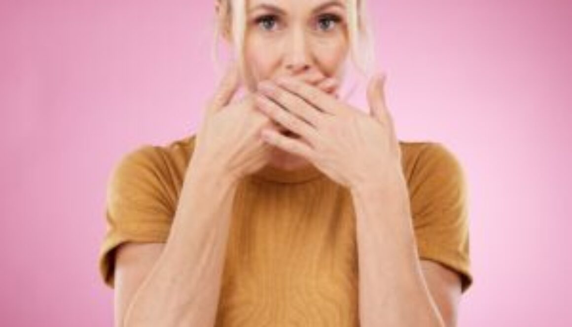 secret-studio-woman-with-her-hand-her-mouth-with-shock-surprise-quiet-face-expression-gossip-shocked-portrait-female-model-with-surprised-gesture-isolated-by-pink-background-min