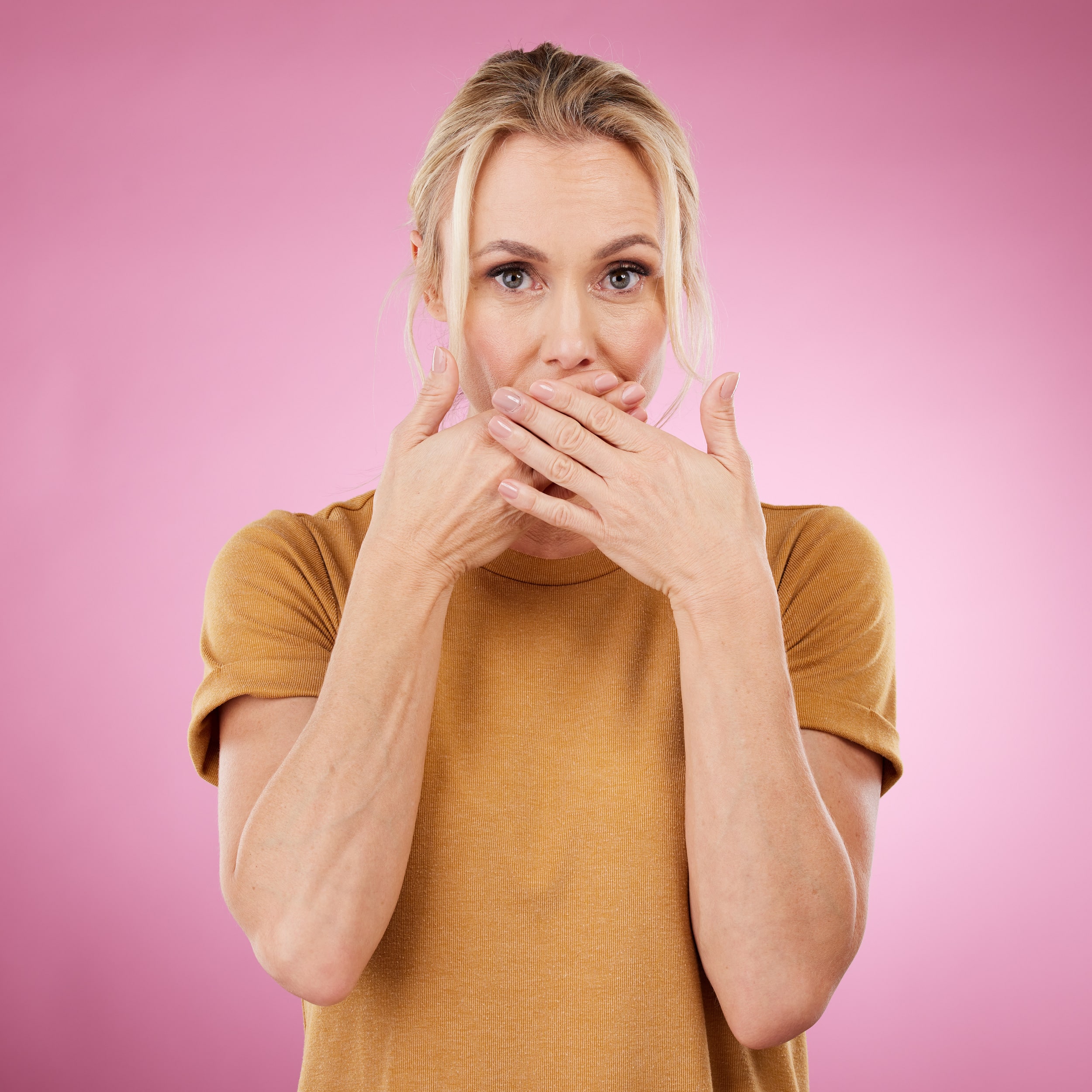 secret-studio-woman-with-her-hand-her-mouth-with-shock-surprise-quiet-face-expression-gossip-shocked-portrait-female-model-with-surprised-gesture-isolated-by-pink-background-min