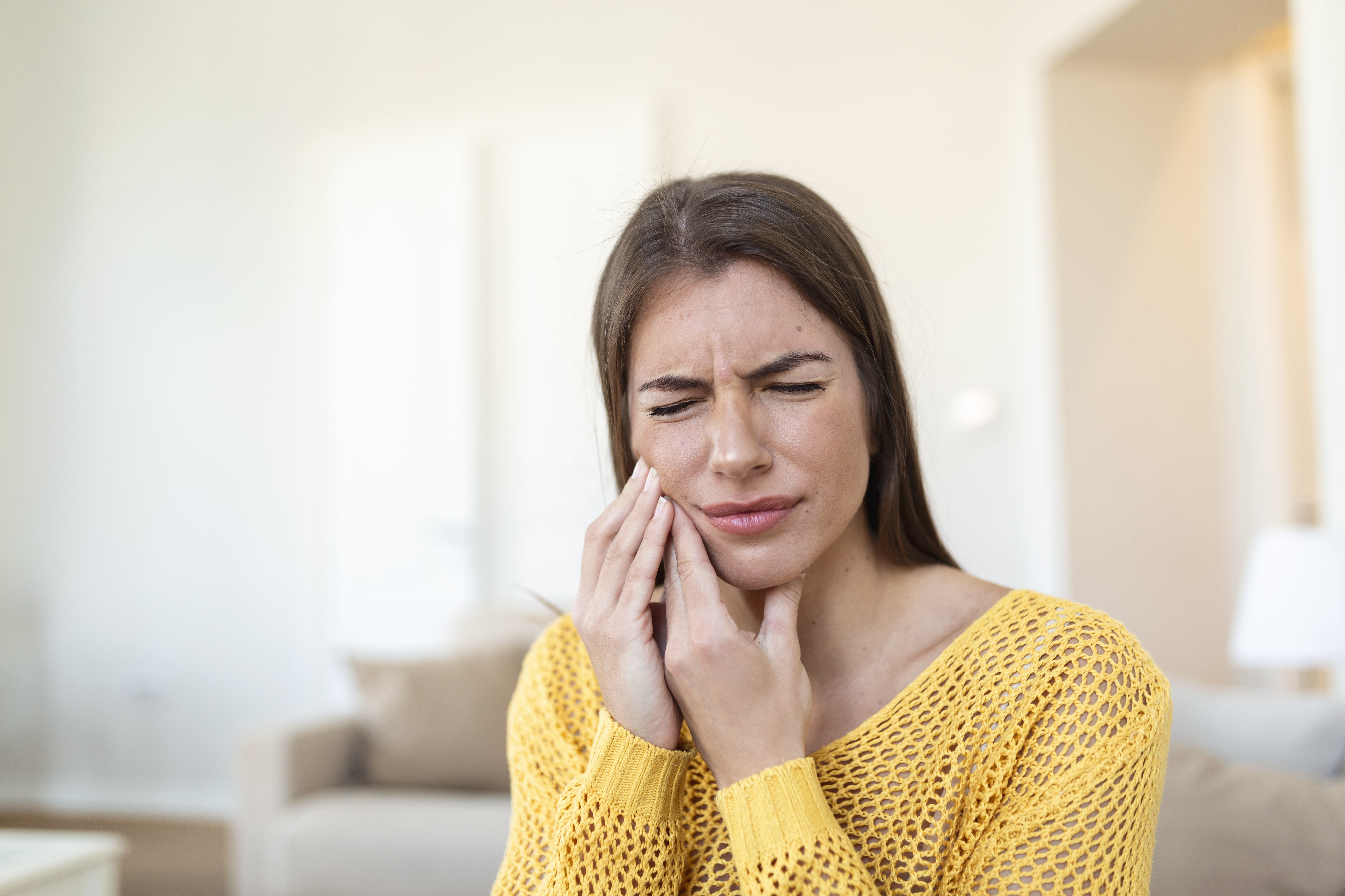 tooth-pain-dentistry-beautiful-young-woman-suffering-from-terrible-strong-teeth-pain-touching-cheek-with-hand-female-feeling-painful-toothache-dental-care-health-concept-high-resolution-min